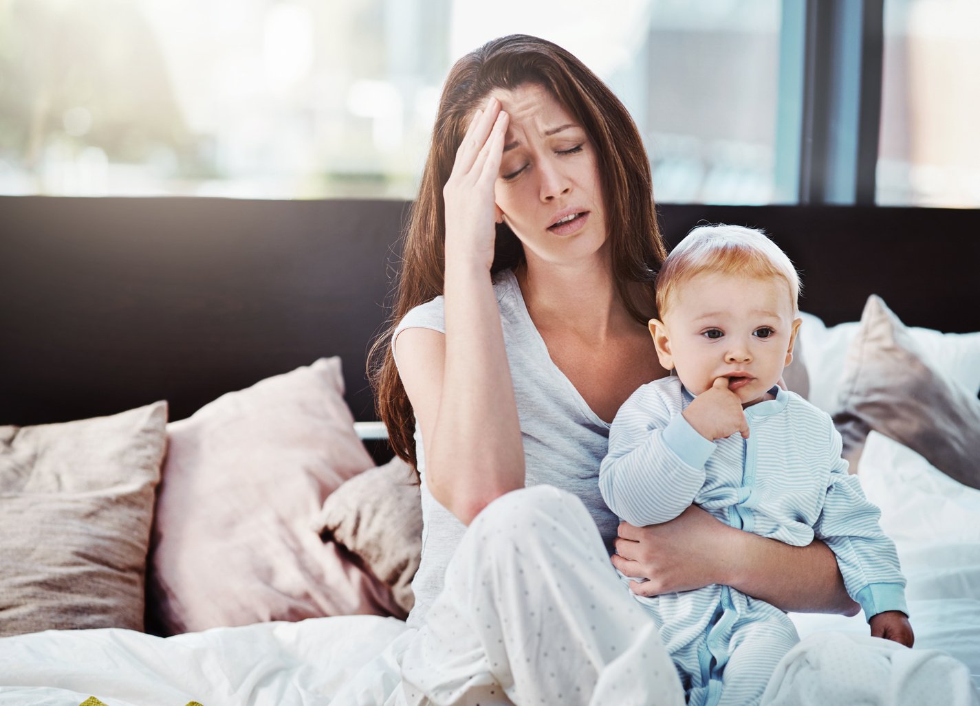 Mother, Baby and Tired or Stress in a Home Bedroom or Bed with Postpartum, Headache or Anxiety. Depression, Mental Health and Burnout of a Woman or Mom with a Child in a  House with Fatigue